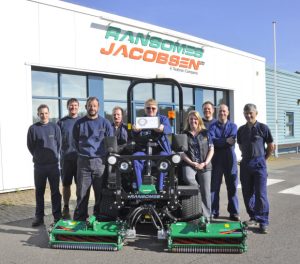 Safety representative Eddie Talbott with the RoSPA award (seated) flanked by Gemma Cosby, Ransomes Jacobsen’s EHS Manager (centre right), and other members of the safety team.
