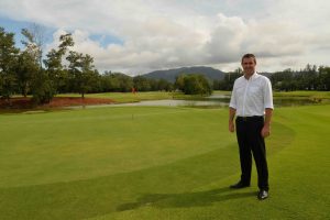 Revamp Transforms Laguna Phuket Golf Club 1 Laguna Phuket's Director of Golf Paul Wilson beside the eighth green with Phuket's iconic mountains in the background.