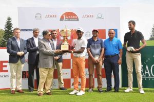 S. Chikka is presented with the trophy.