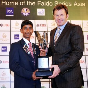 Rashid Khan receives the Faldo Series Asia Grand Final trophy from Sir Nick Faldo.